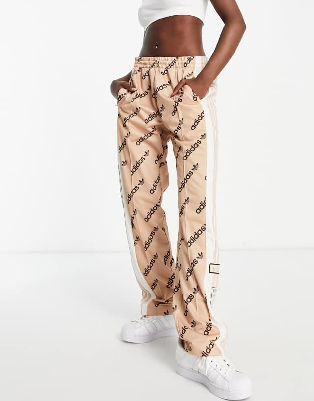 adidas Originals 'Logomania' repeat logo adibreak side snaps track pants in blush