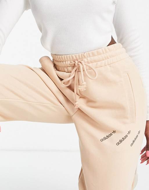 adidas Originals 'Logomania' triple logo joggers in blush | ASOS