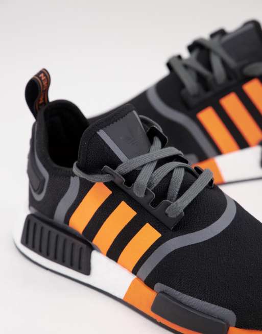 adidas Originals NMD R1 Sneaker in Schwarz mit orangefarbenen Streifen ASOS