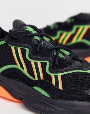 adidas originals ozweego sneakers in black with neon stripes