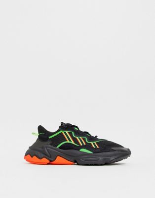 adidas originals ozweego sneakers in black with neon stripes