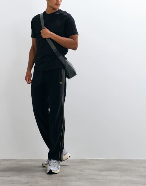 adidas Originals - pantalones de chándal de terciopelo Firebird en negro - view 1