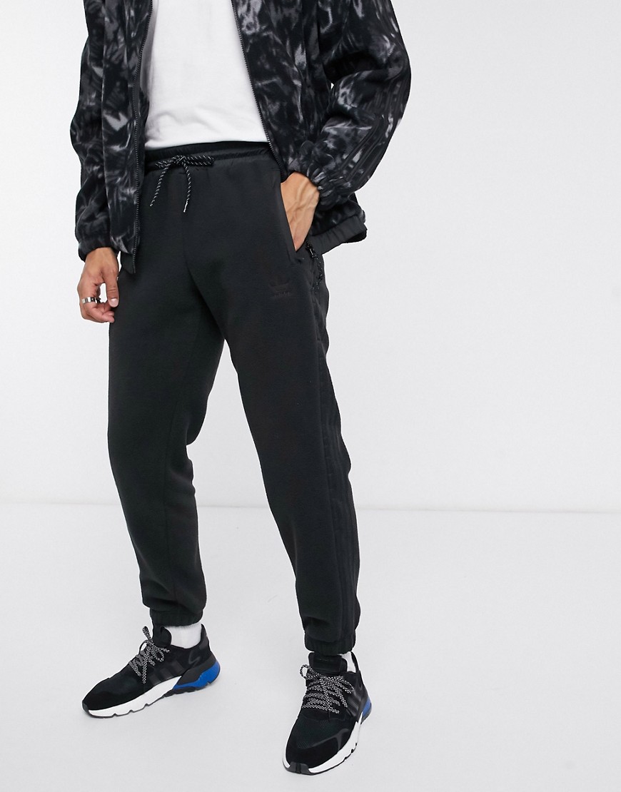 adidas originals polar fleece joggers in black with reflective details in black tech pack