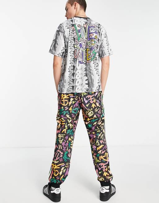 adidas Originals Pride printed track pants in black with Love