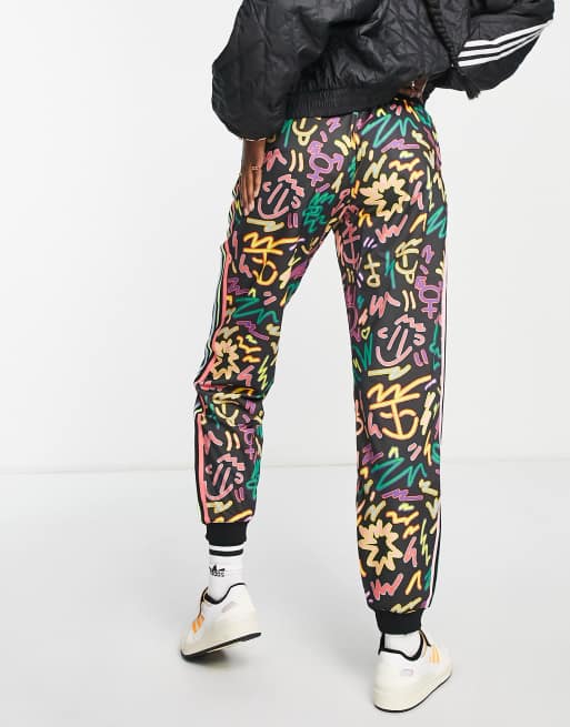 Originals Pride printed track pants in black with Love Unites print | ASOS