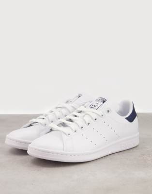 white and navy adidas trainers