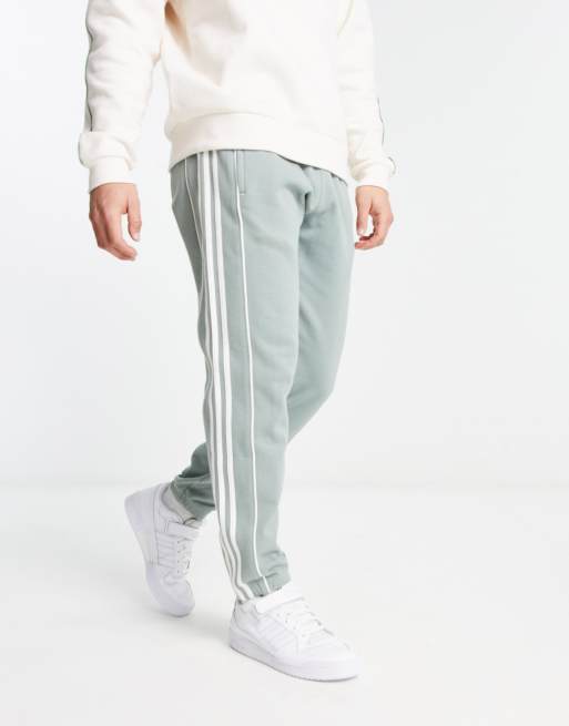 adidas Originals Rekive stripe logo joggers in green ASOS