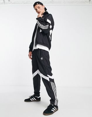 adidas Originals Rekive 3 stripe logo trackpants in black - ASOS Price Checker