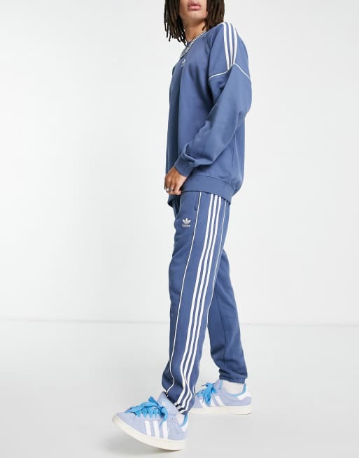 adidas Originals Rekive three stripe joggers in blue