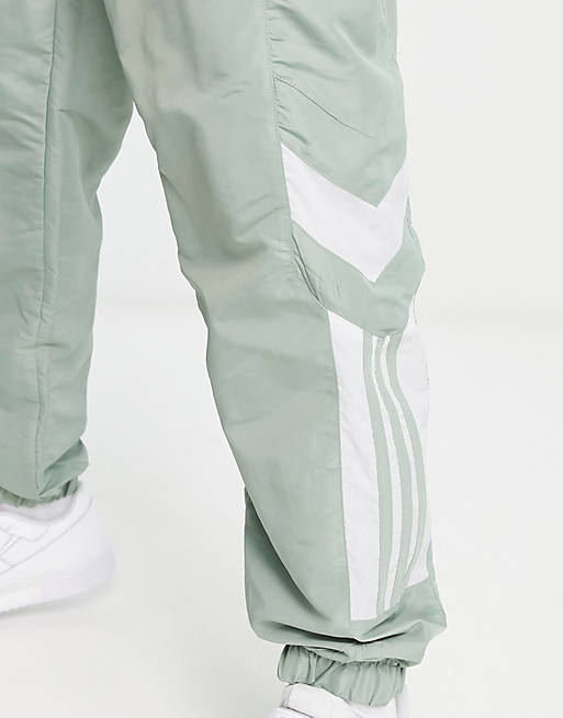 adidas Originals – Rekive – Trainingshose in Grün aus Webstoff mit  Ziereinsätzen | ASOS
