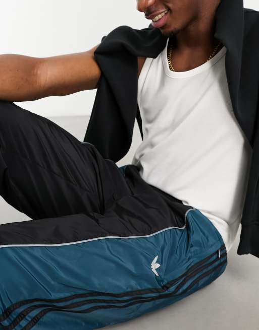 adidas Originals – Rekive – Trainingshose in Schwarz und Blau mit