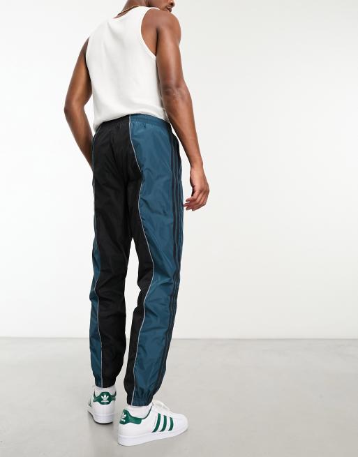 adidas Originals – Rekive – Trainingshose in Schwarz und Blau mit