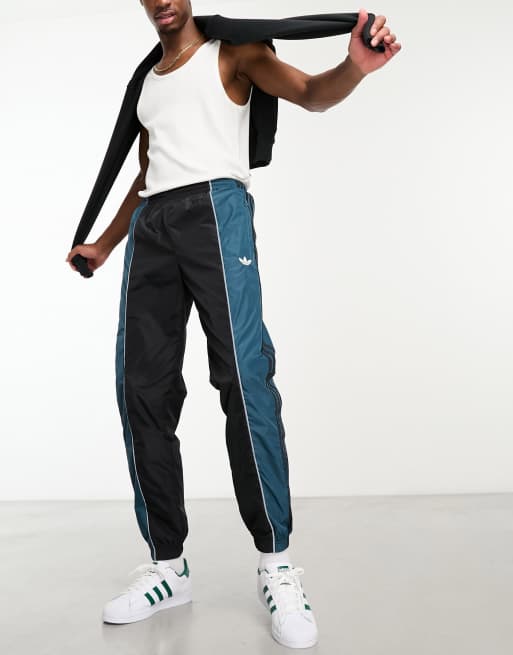 adidas Originals – Rekive – Trainingshose in Schwarz und Blau mit