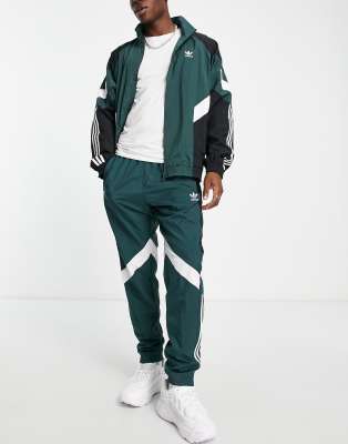 adidas Originals Rekive woven track pants in light green with graphic detail