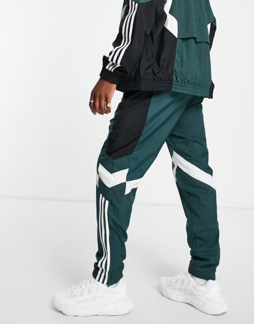 adidas Originals Rekive woven track pants in light green with graphic detail