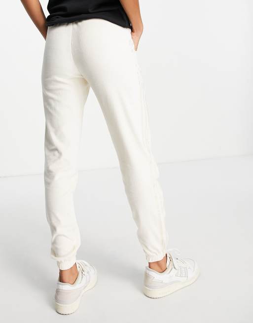 adidas Originals 'Relaxed Risque' velour sweatpants in off white