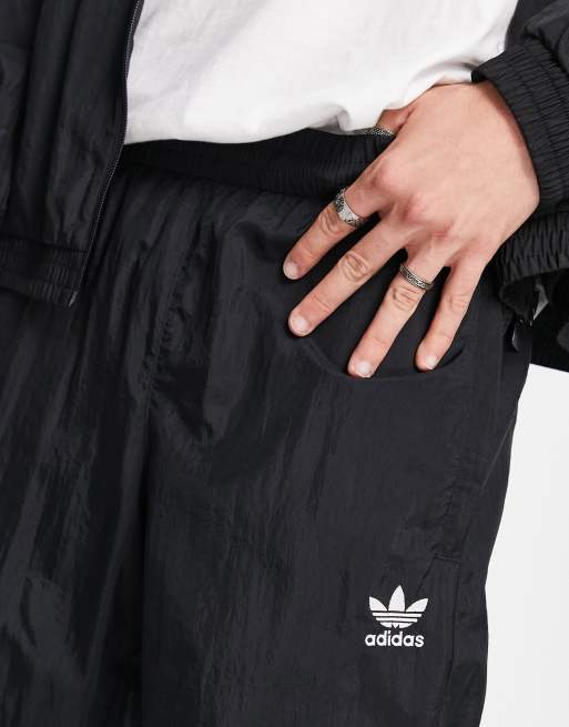 adidas Rikeve cut 3-Stripes track pants in black | ASOS