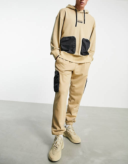 adidas Originals RYV joggers in beige tone with leg pockets
