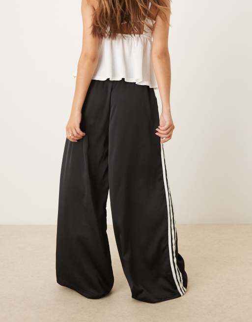 adidas Originals satin wide leg trackies in black with ruffle 3 stripe