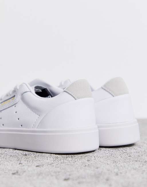 Adidas originals sleek over branded trainers in white best sale