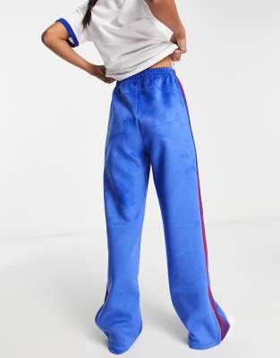 adidas Originals sports style track pants in blue with tape