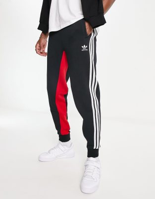 adidas Originals three stripe joggers in red