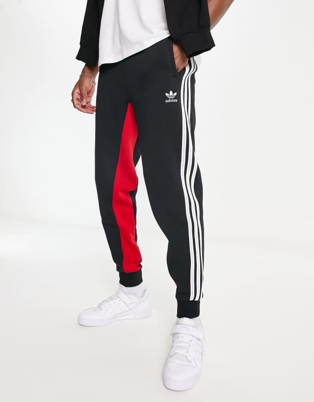 adidas Originals SPRT three stripe joggers in black and red