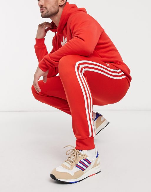 Adidas sst store track pants red