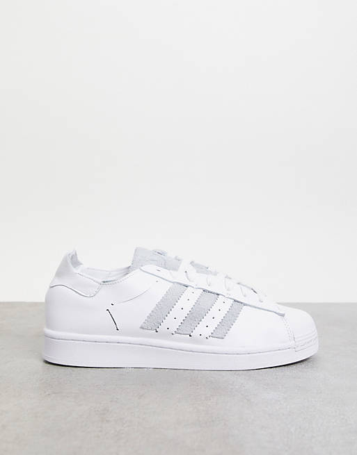 adidas Originals Superstar minimalist trainers in white with grey stripes