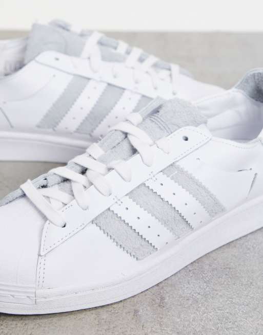 adidas Originals Superstar minimalist trainers in white with grey