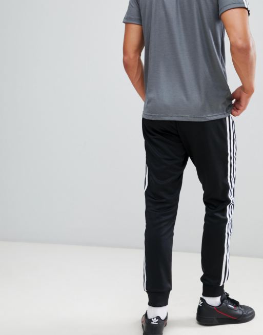 adidas Originals Superstar Skinny joggers cuffed in black cw1275