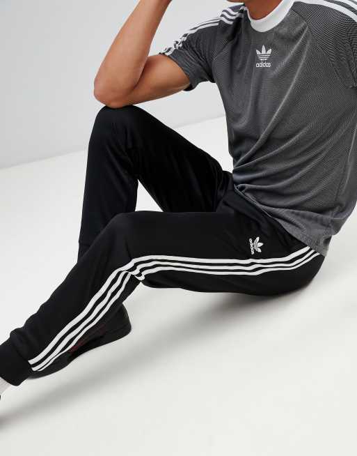 adidas Originals Superstar Skinny joggers cuffed in black cw1275