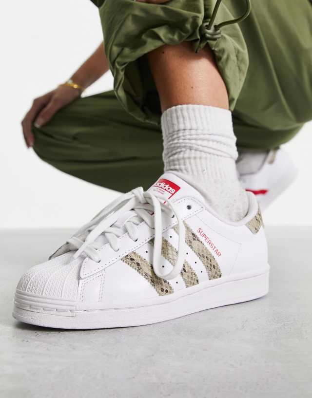 adidas Originals Superstar snake print sneakers in white