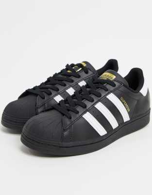 Shop Adidas Originals Superstar Sneakers In Black And White