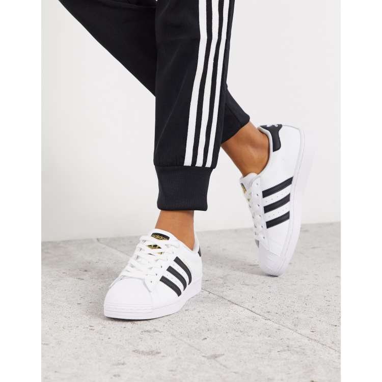 Adidas originals white store with black stripes