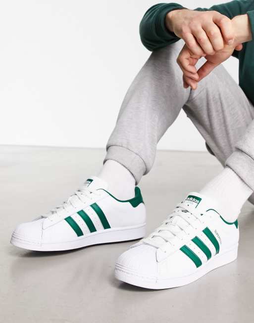 adidas Originals Superstar sneakers in white and green