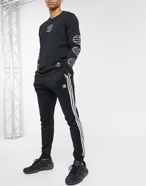 adidas Originals Superstar three stripe skinny joggers in black