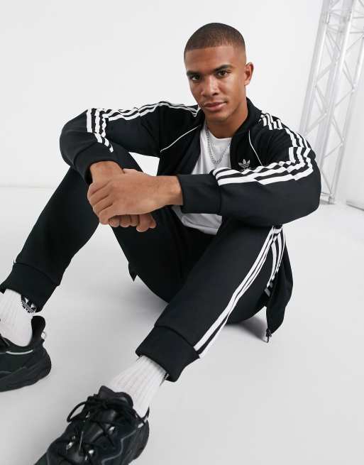 Adidas original three stripe track best sale jacket with vintage logo in black