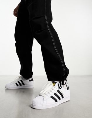 white adidas trainers with black stripes