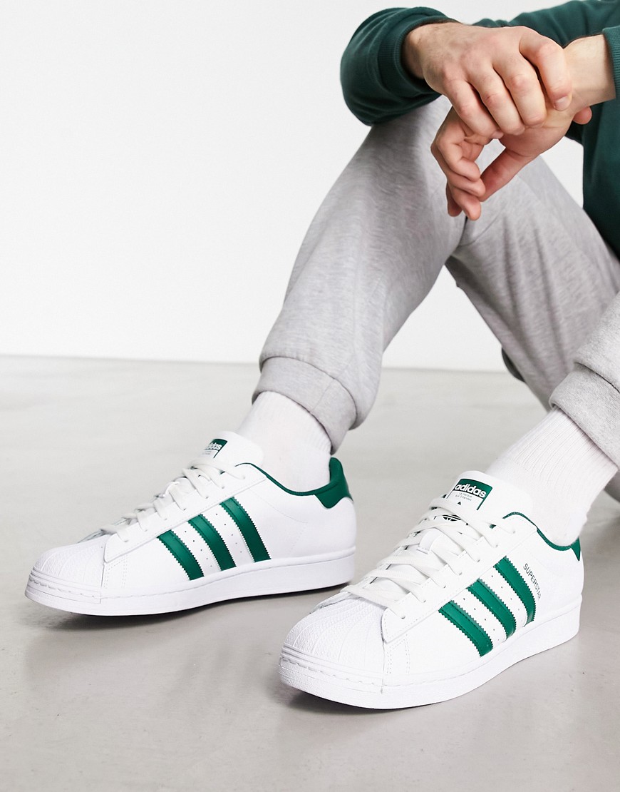 adidas Originals Superstar trainers in white and green
