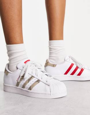 adidas Originals Superstar trainers in white and snake print