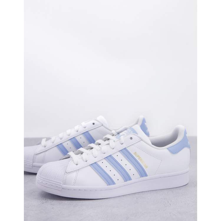 adidas Originals Superstar trainers in white with light blue stripes