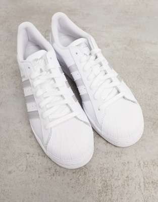 white and silver adidas trainers