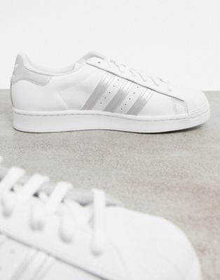 white adidas trainers with silver stripes