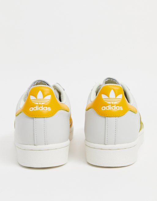 Adidas white shop and yellow shoes