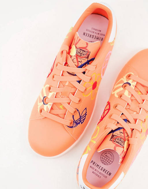 adidas Originals Sustainable Stan Smiths in orange with all-over graphic  print | ASOS