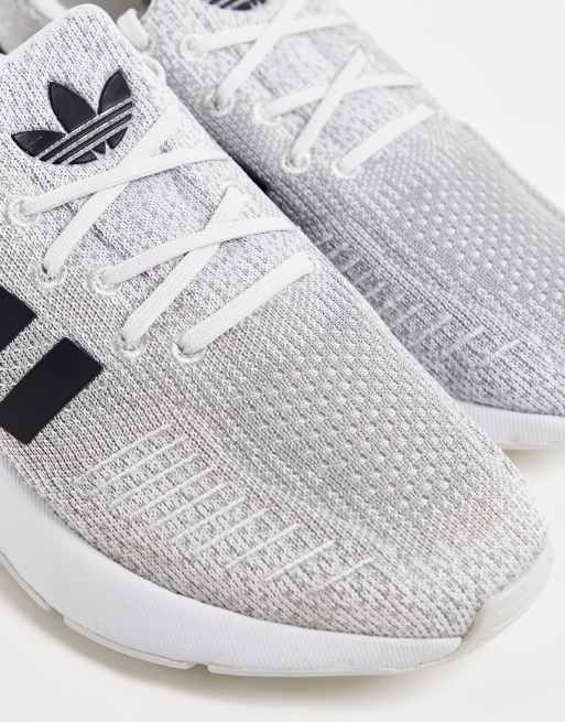 White adidas sneakers with cheap black stripes