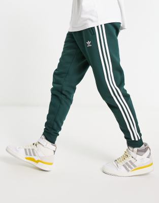 White adidas pants with green stripes sale