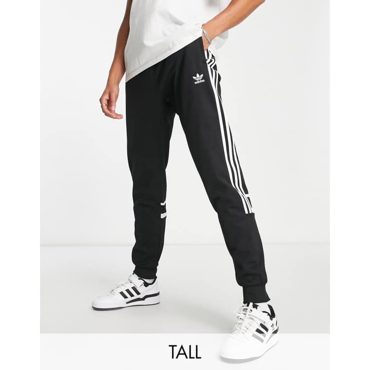 adidas Originals Tall sweatpants | in black ASOS Challenger fit adicolor slim stripe three