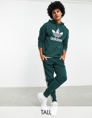 adidas Originals Tall adicolor three stripe joggers in green